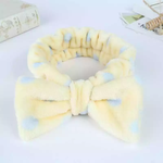 Load image into Gallery viewer, Soft yellow bow tie headband. Yellow and blue polka dot fleece hair band.
